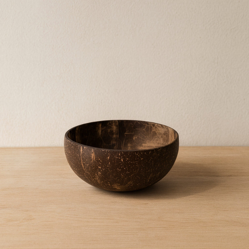 Wooden coconut bowl on a wooden surface with a neutral background