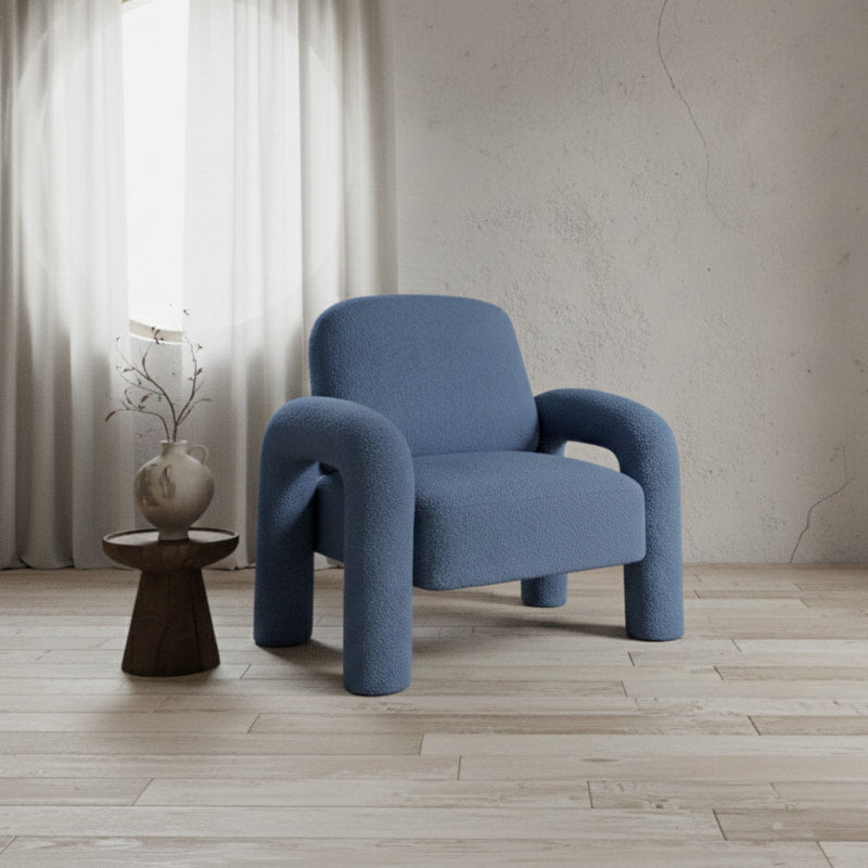 cute reading chair in a room with a wooden floor and light-colored walls.
