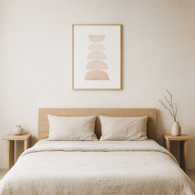 Neatly made bed with wooden headboard and side tables, decorating with abstract art​.