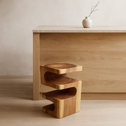 Designer bar stools in front of a kitchen wood counter with a vase on top.