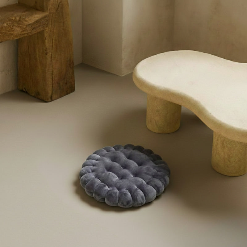 floor cushions for adults on a beige floor with a stone bench in the background