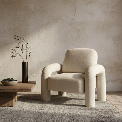 fluffy white chair for room​ in a minimalistic room with a textured wall and wooden coffee table.