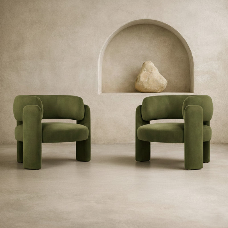 Two green upholstered armchairs in a wabi sabi minimalist room.