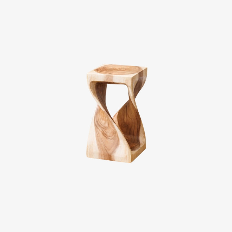 handmade wooden stool in front of a wooden desk with a vase on a neutral background