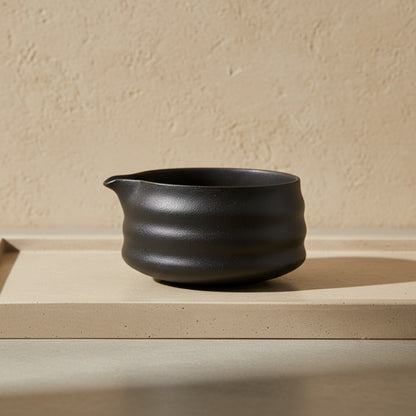 harmony matcha tea​ bowl on a beige surface with a beige background