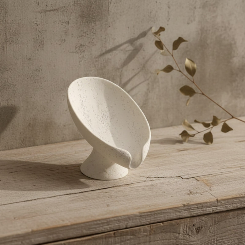 White holder for soap on a wooden surface with a neutral background