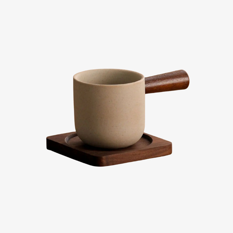 huge coffee mug​ with wooden handle on a wooden coaster against a white background