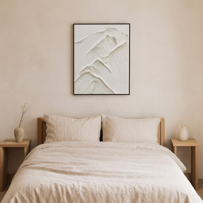 Beige bedroom with a bed, nightstands, and a interior design white paint​ piece on the wall.