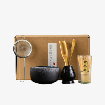japanese vintage tea set​ with a box, bowl, whisk, spoon, and glass on a white background