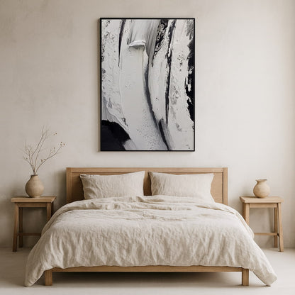 Bedroom with wooden bed, beige bedding, and large wabi sabi art​.