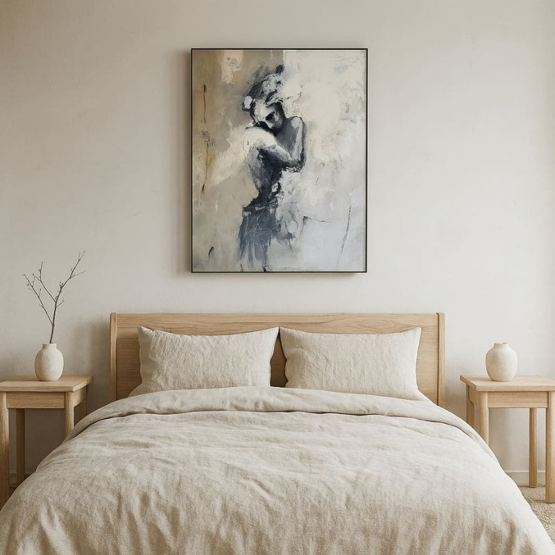 Bedroom with wooden bed, beige bedding, and large wabi sabi wall art