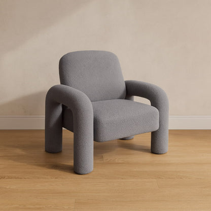 light grey chair fluffy chair​ on a wooden floor with a beige wall background