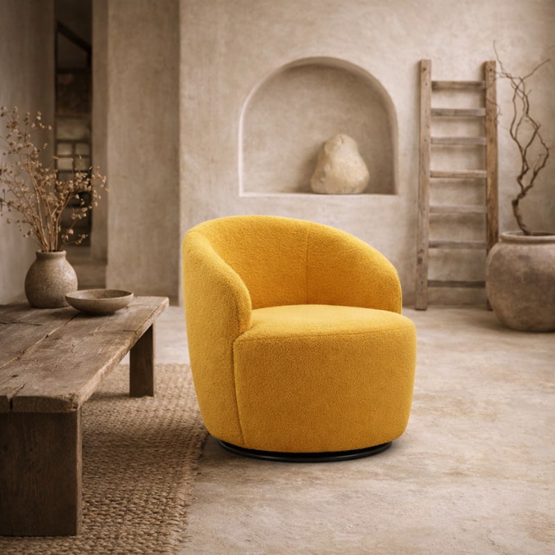 Yellow lounge chair in a rustic room with wooden table and stone wall.