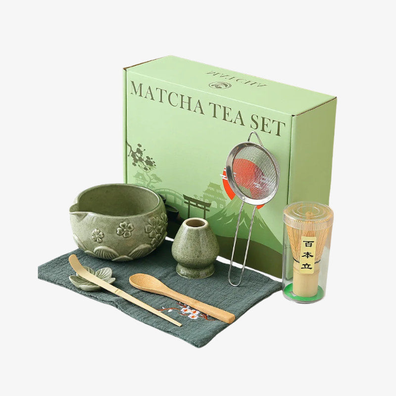 Matcha tea set Japan with green box, bowl, whisk, spoon, and cup on a white background