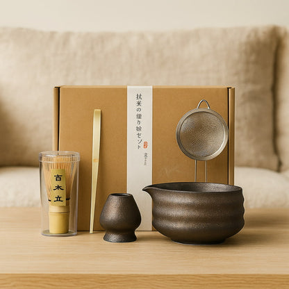 Matcha tea set with a pot, strainer, and other items on a wooden surface.