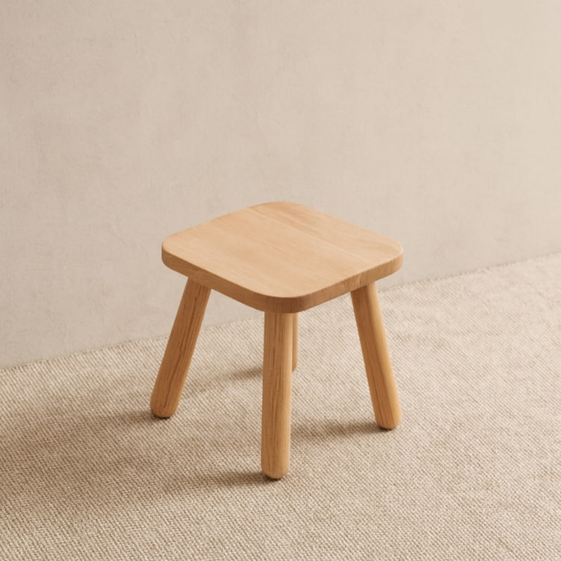 minimalist stool on a textured beige surface with a neutral background