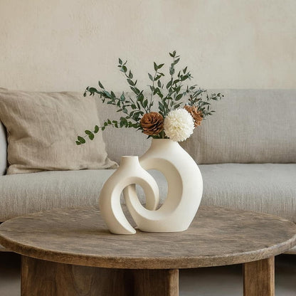 modern ceramic flower vases on a wabi sabi wooden table.