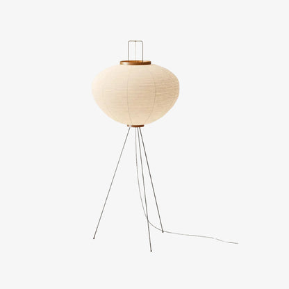 modern floor lamp japandy ambient light​ with a round beige shade and metal legs on a white background