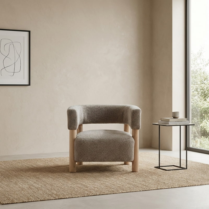 modern minimalist accent armchair with a side table and abstract art.