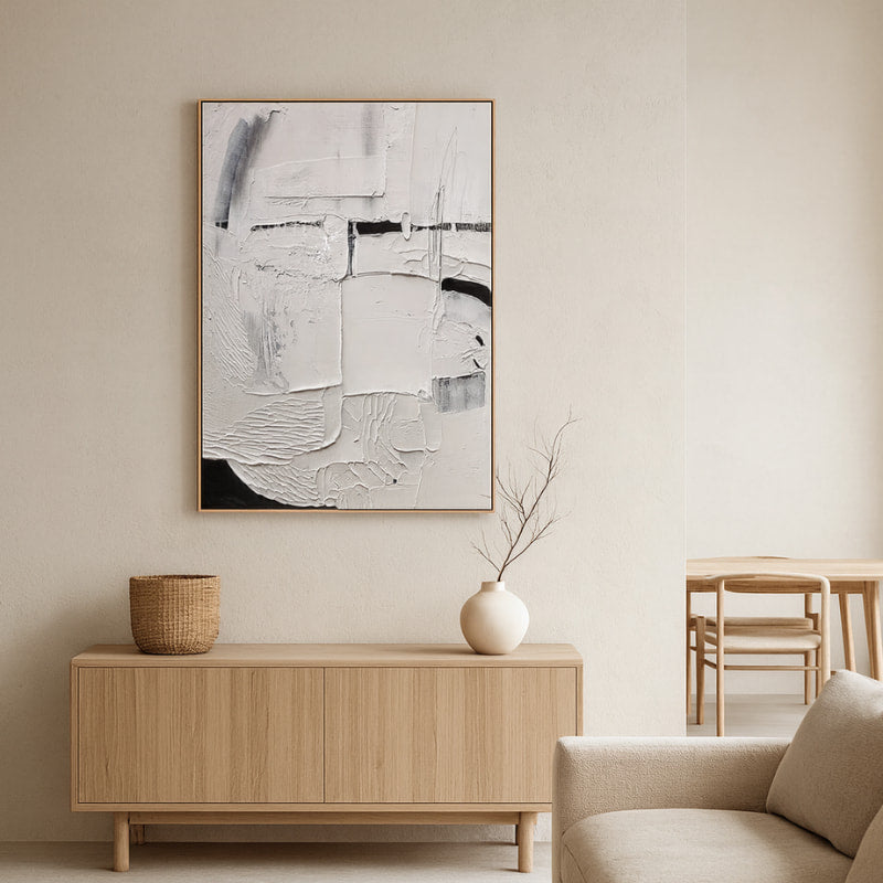 modern wall art for living room​ above a wooden console table with a vase.