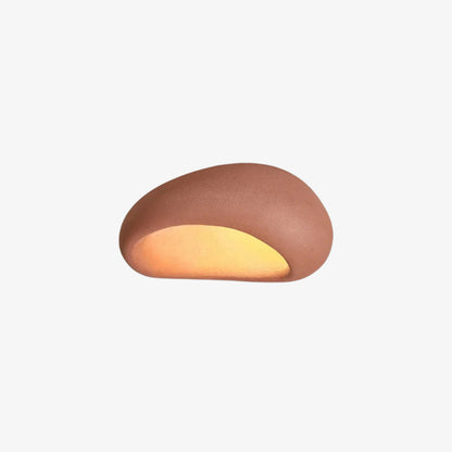 Cylindrical round pink lamp​ with a warm glow on a white background