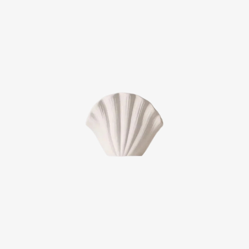 White ceramic shell vase on a white background