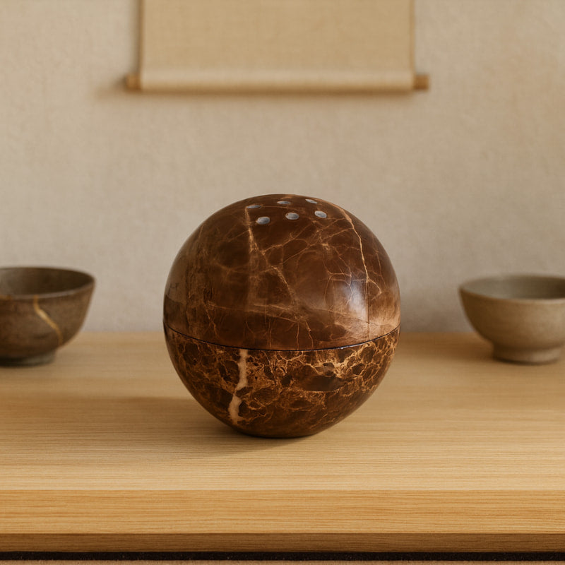 stoner incense burner​ on a wooden table with wabi sabi ceramic around.