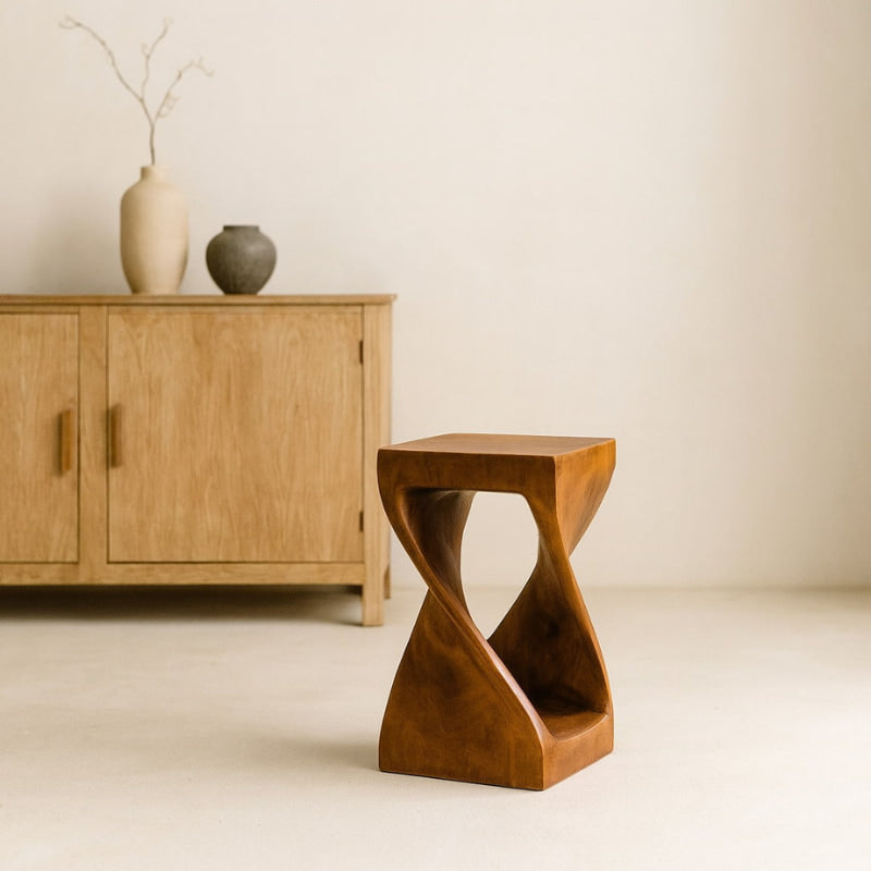 tall counter bar stool with a unique design in front of a wooden cabinet.