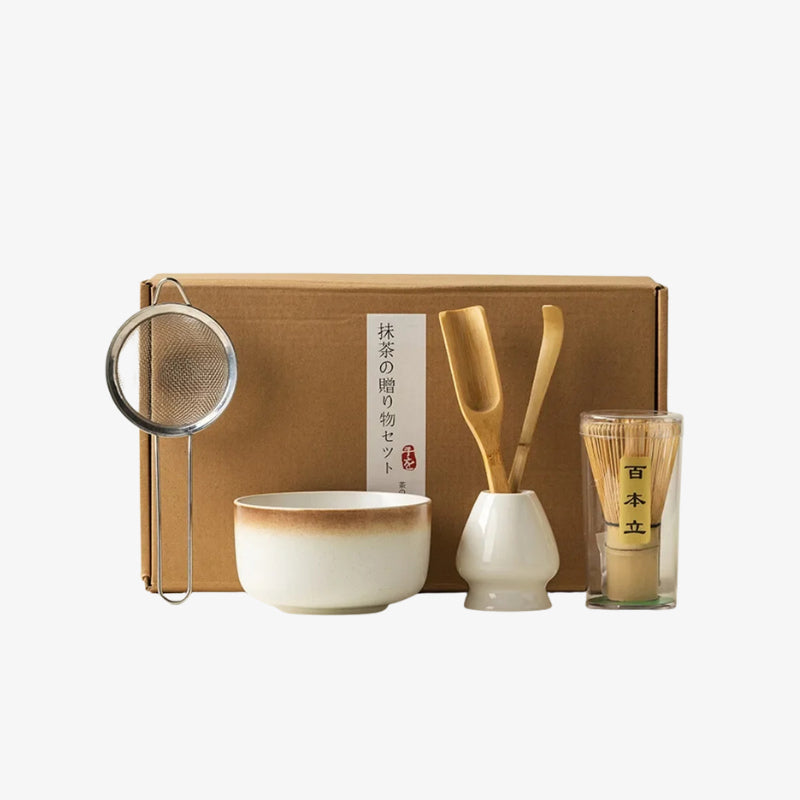 Tea set matcha with a bowl, whisk, spoon, and glass on a white background