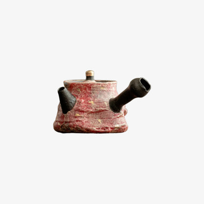 Ceramic teapot design with a textured surface on a white background