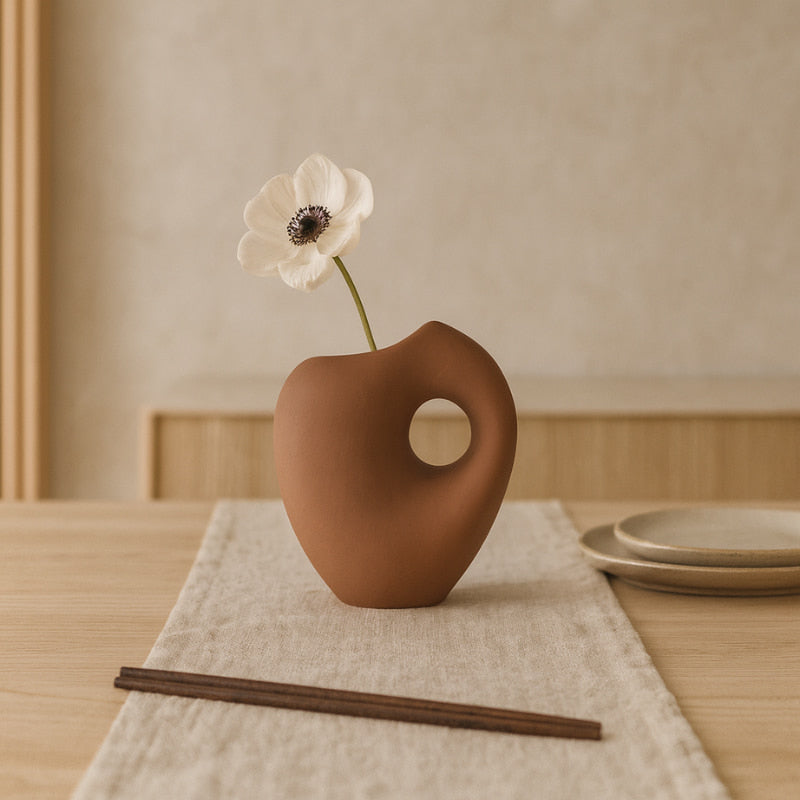 unique vase shapes​ on a textured beige surface with a neutral background