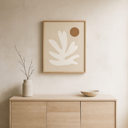 Wabi sabi art print​ on a wall above a wooden cabinet with decorative items.