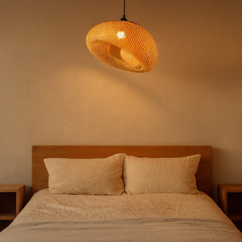 Bedroom with a wooden headboard, beige bedding, and a wabi sabi bamboo fixture lamp.