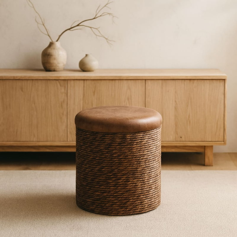 wabi sabi brown storage ottoman in front of a wooden cabinet with decorative vases.
