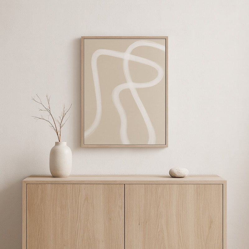 Beige wabi sabi canvas art on a wall above a wooden cabinet with decorative items.
