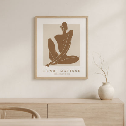 wabi sabi print​ artwork on a wall above a wooden cabinet.