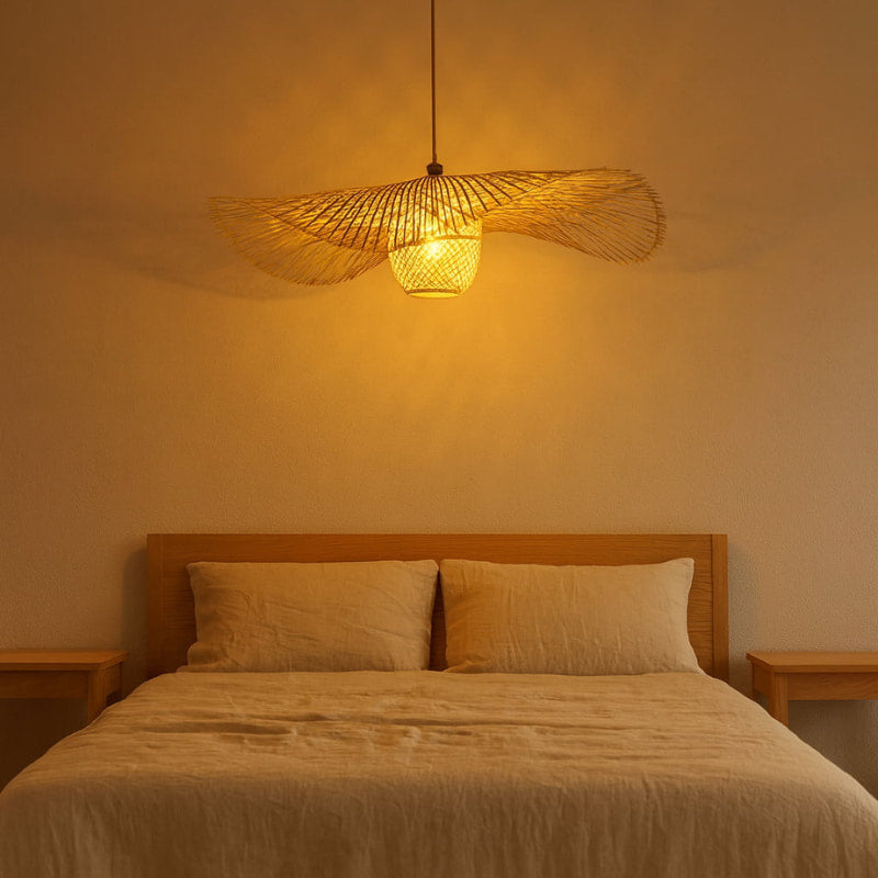 Bedroom with wooden headboard, beige bedding, and a wabi sabi rattan pendant light.