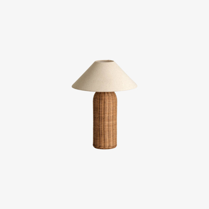 Wabi sabi table lamp with wicker base and beige lampshade on a white background