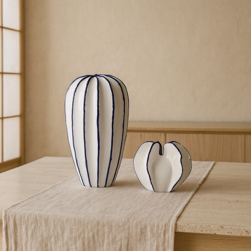 wabi sabi vase​ on a wooden table in a beige background