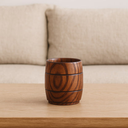 wood coffee mug​ on a wooden table with a beige sofa in the background